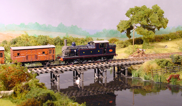 A GER Class M15 2-4-2T Locomotive crosses the river with a passenger train